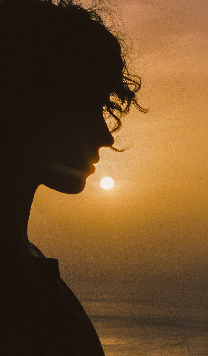 ba&sh sustainable collection - image of a woman looking out into the sunset