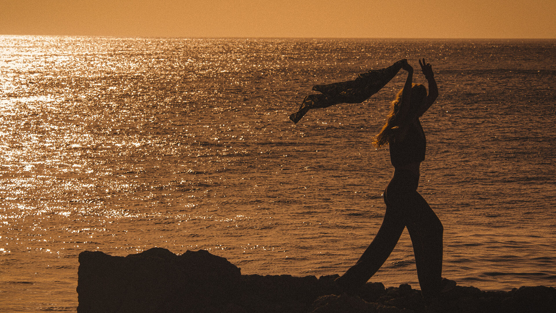 ba&sh sustainable collection. Image of a woman stretching at sunrise