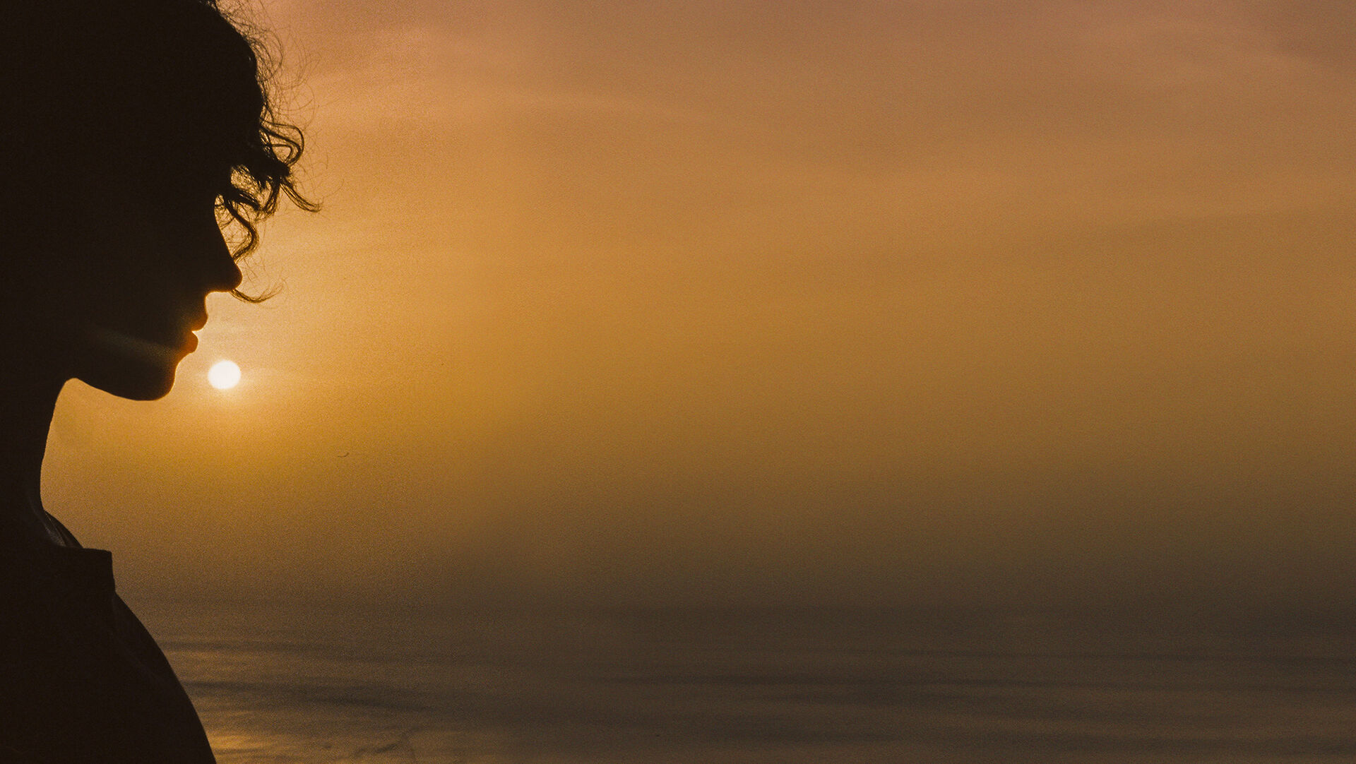 ba&sh sustainable collection - image of a woman looking out into the sunset