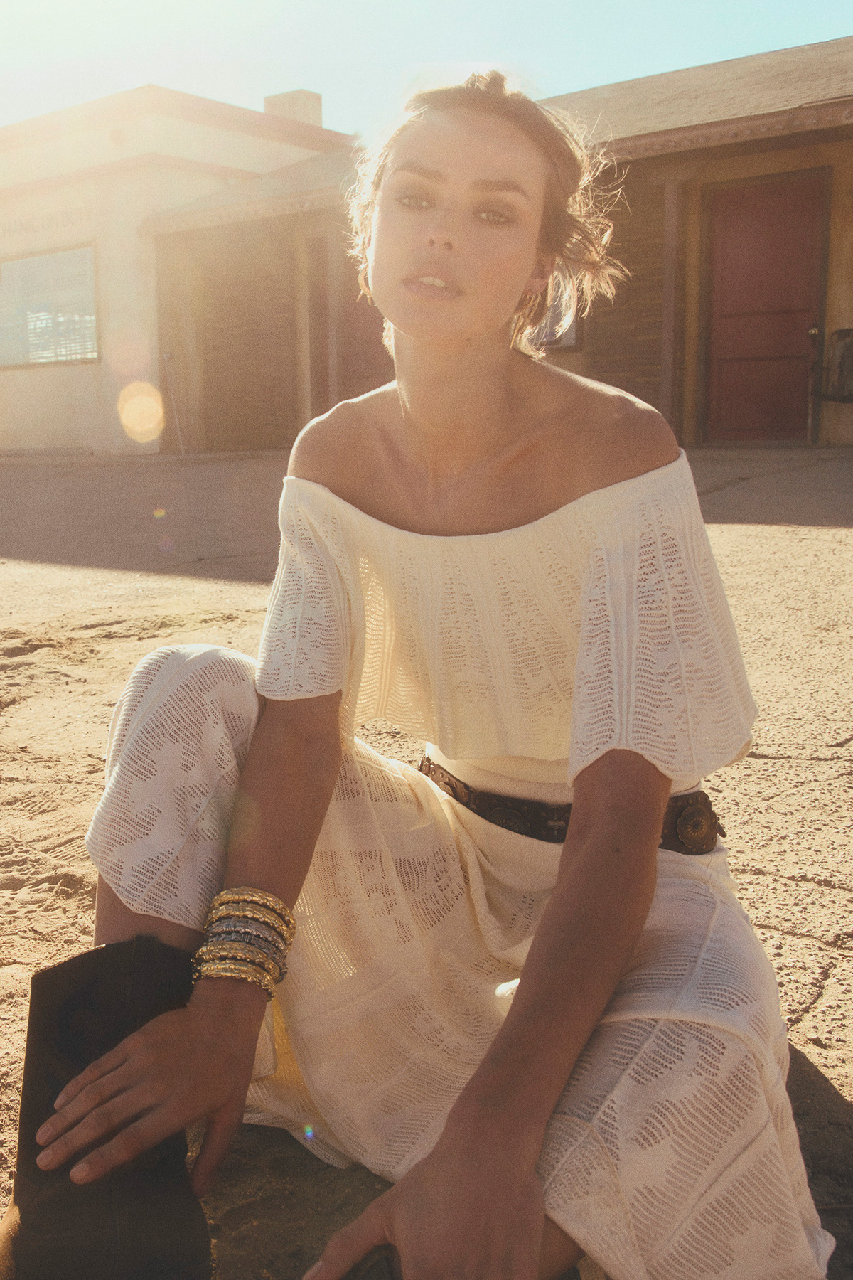 A model wearing a white knit dress
